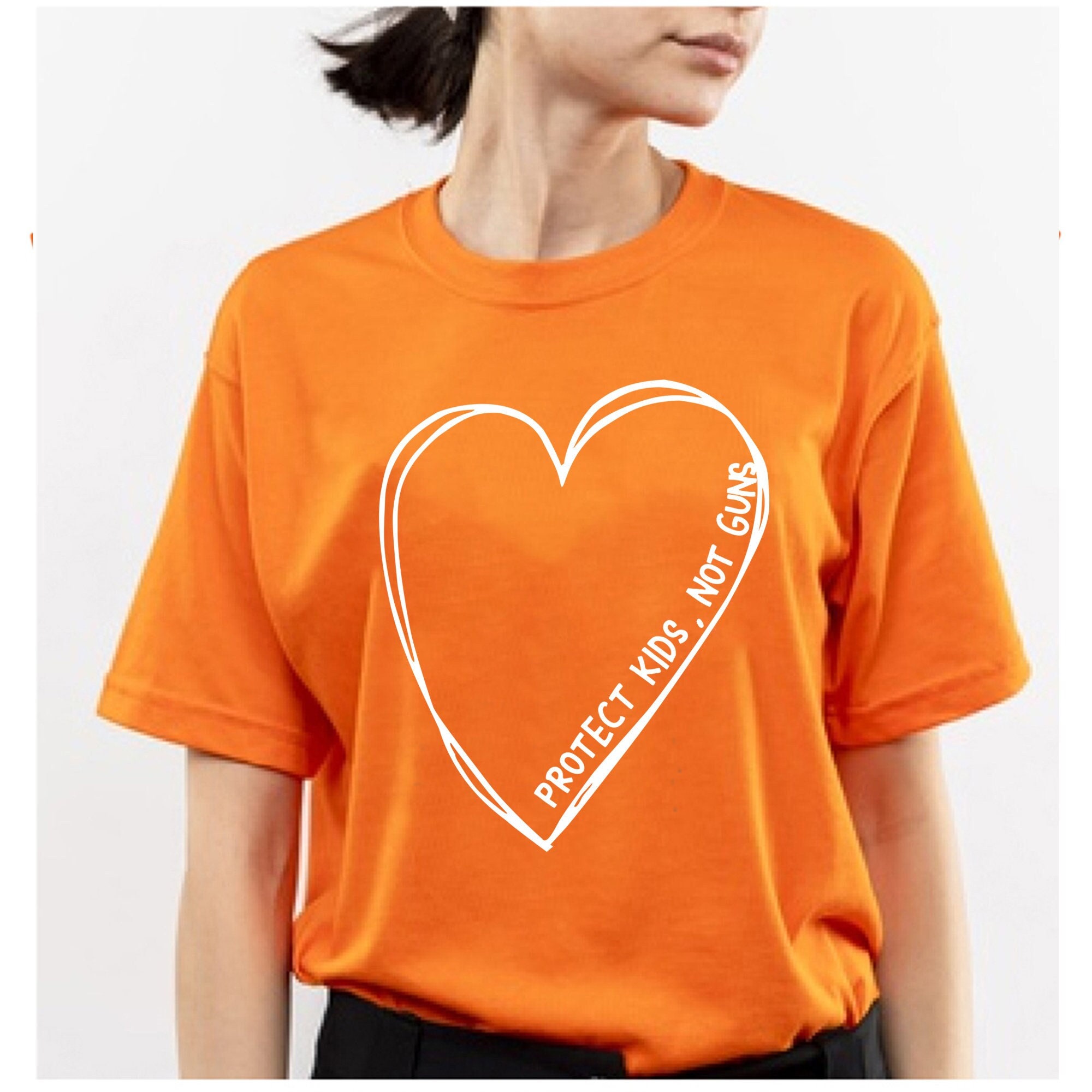 Protect Kids Not Guns Big Heart Unisex T-Shirt Protect Kids Not Guns Big Heart Unisex T-Shirt