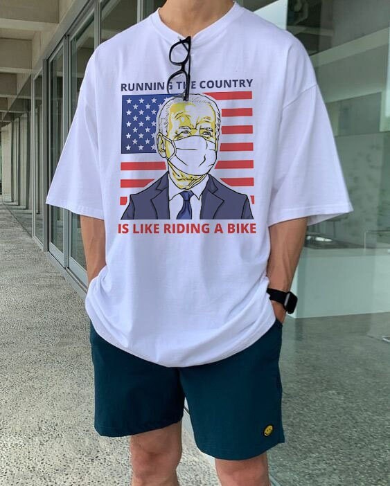 Running The Country Is Like Riding A Bike Funny Biden American Flag Unisex T-Shirt Running The Country Is Like Riding A Bike Funny Biden American Flag Unisex T-Shirt