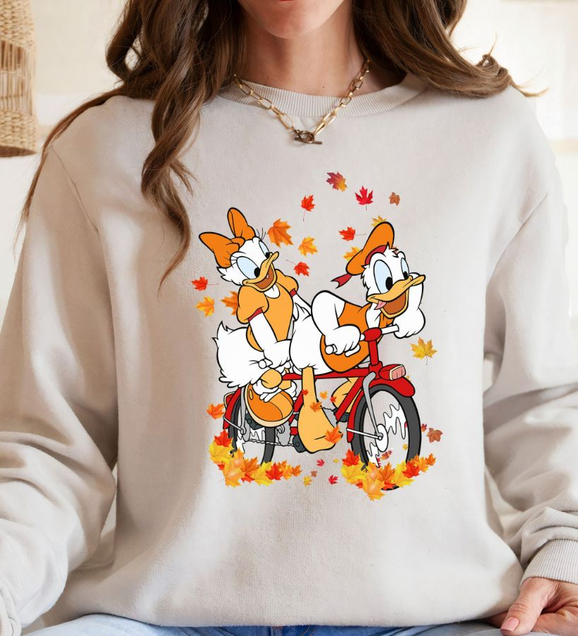 Disney Donald Duck Daisy Duck Riding Bike The Maple Tree Leaves Halloween Fall Sweatshirt Disney Donald Duck Daisy Duck Riding Bike The Maple Tree Leaves Halloween Fall Sweatshirt