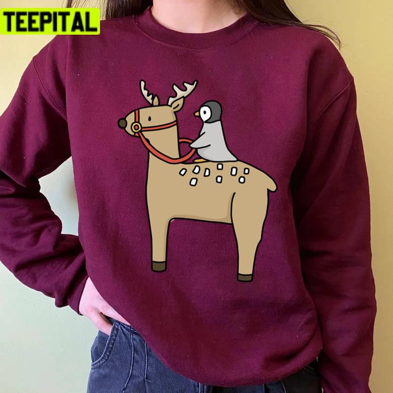 Penguin Riding A Reindeer Christmas Unisex Sweatshirt Penguin Riding A Reindeer Christmas Unisex Sweatshirt